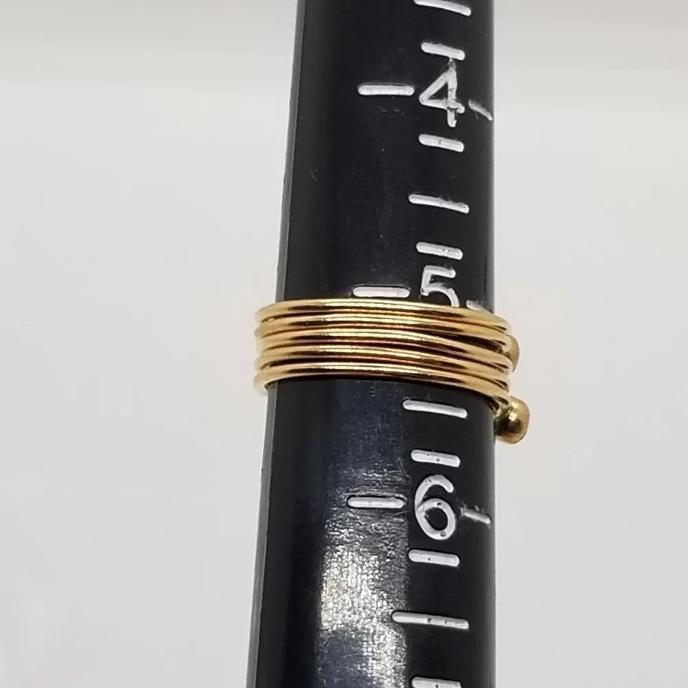 set of 5 gold tone stacking rings with small blue cabochon size 5.25